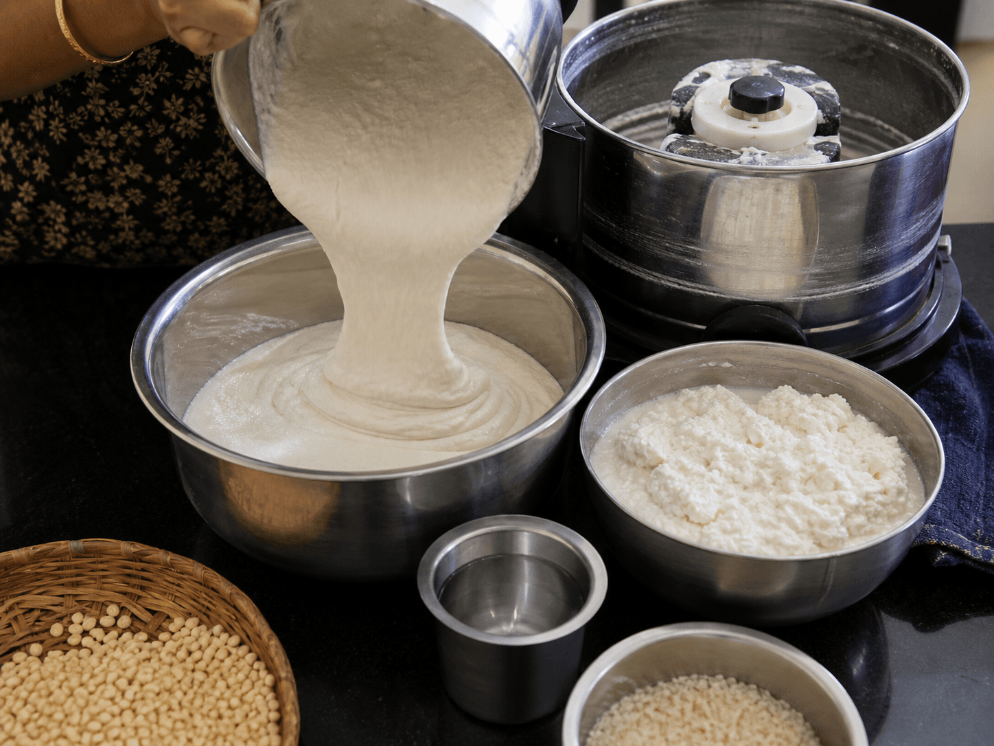 Grinding fluffy white Mallige idli batter in a kitchen grinder